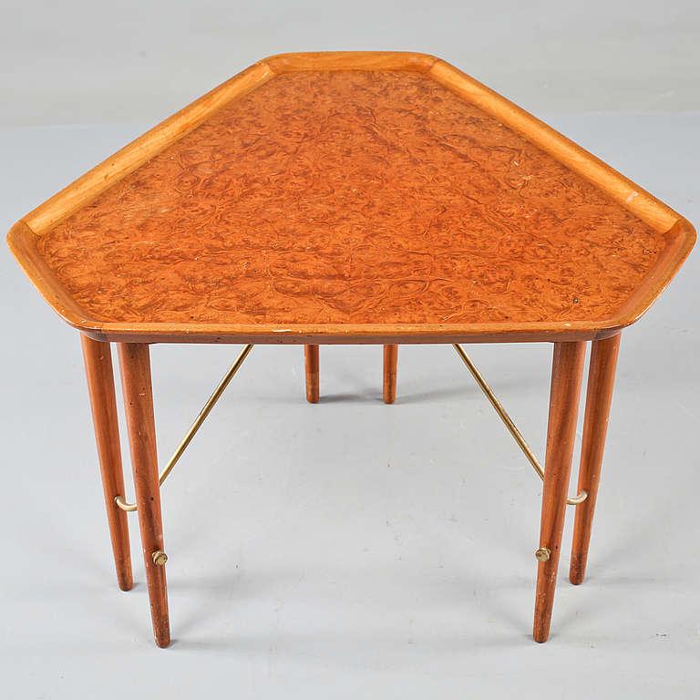 A coffee or large side table designed by Ferdinand Lundquist, Sweden, circa 1950.

Mahogany with burl maple veneer top and brass rod. Measures: Length 75 cm, width 75 cm, height 58 cm.
Restored finish.