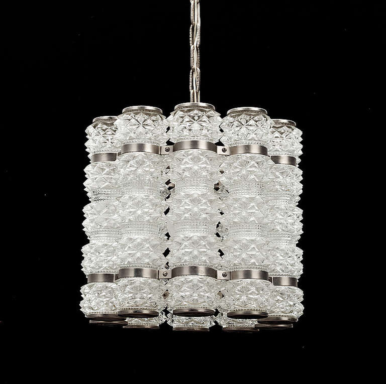 A Pendant by Konst Hant Verk, Tyringe, Sweden. Circa 1960th-70s.
Glass probably by Orrefors
Textured glass with nickel   plated hardware. Glass heigh 9