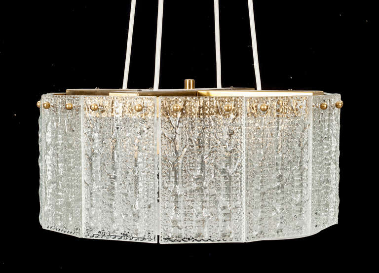 A Pendant by Carl Fagerlund for Orrefors. Sweden.
Textured glass with brass hardware. Diam. 16"; Glass H -7"
Existing European wiring , rewiring available upon request.