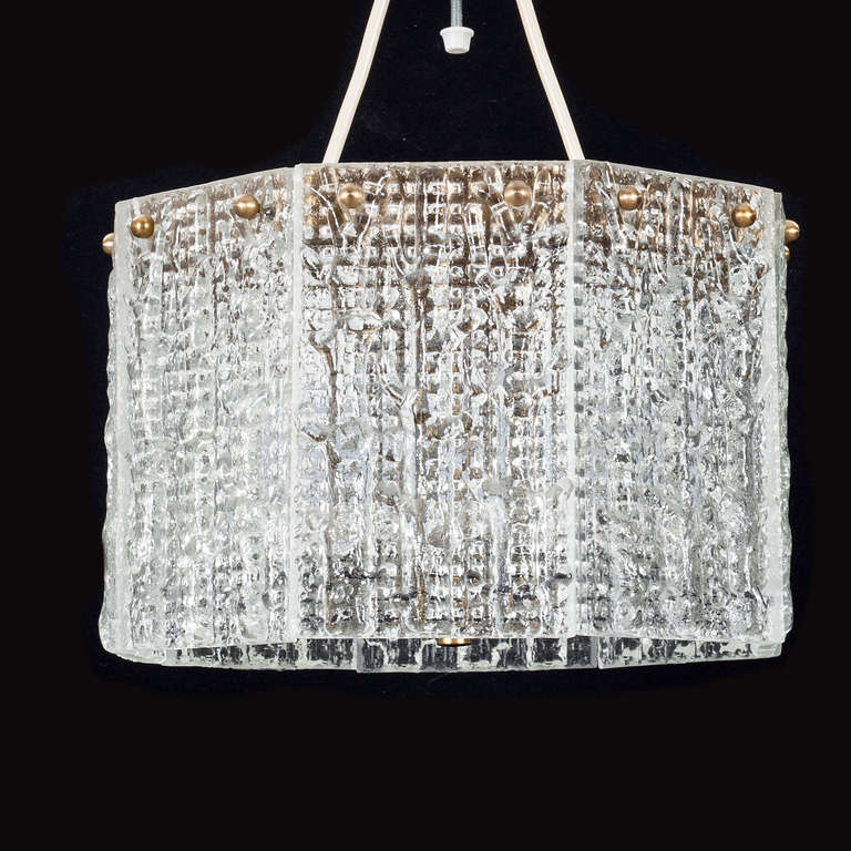 A Pendant by Carl Fagerlund for Orrefors. Sweden, Circa 1960th.
Textured glass and brass hardware. Diam. 12
