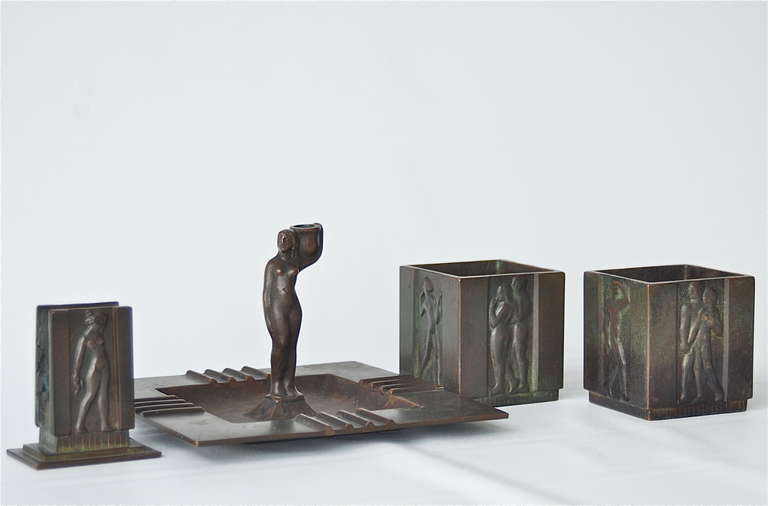 Swedish Art Deco Smoking Set in Bronze, by GAB circa 1930s. Includes ashtray with candleholder, match box holder, and two cigarette holders. Patinated bronze with nude scenes reliefs. Marked by manufacturer.