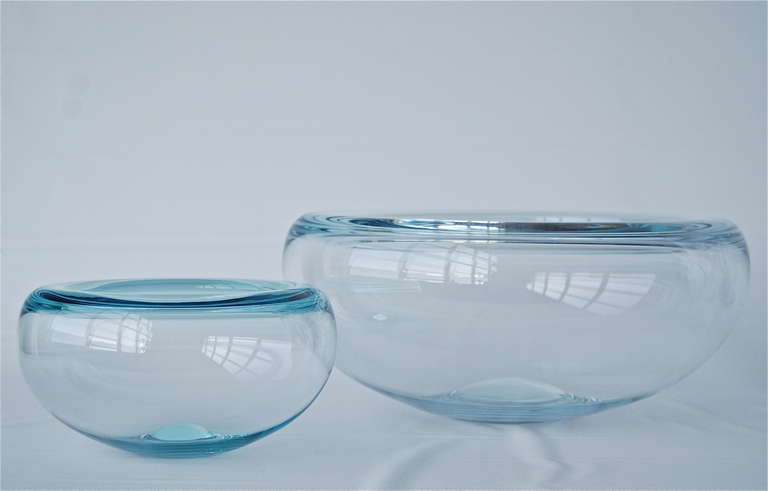 A pair of bowls designed by Per Lutken for Holmegaard, Denmark, circa 1960s.
Large bowl almost clear with hint of blue, smaller bawl in aqua.
Diameter 13