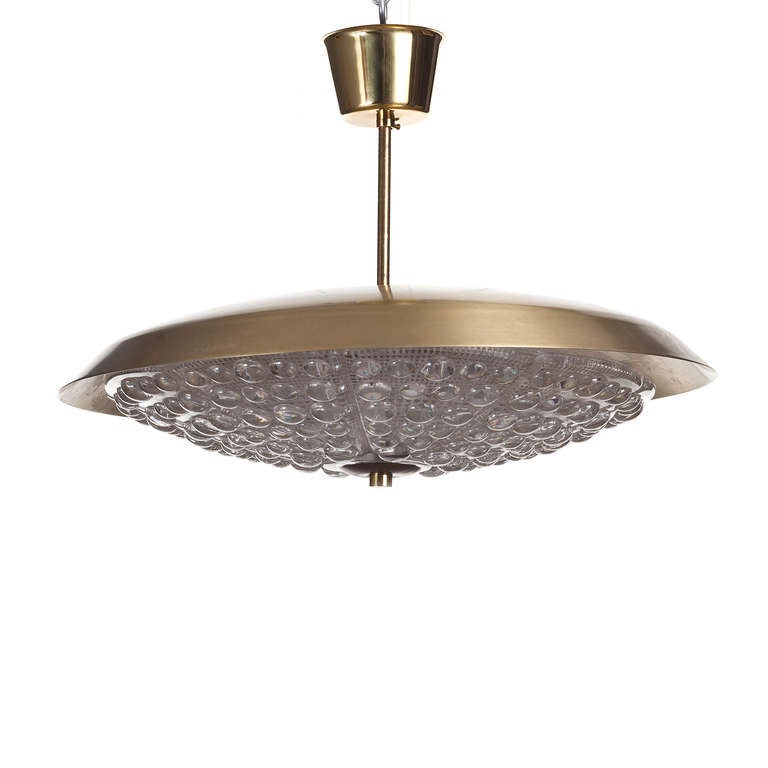A vintage chandelier by Carl Fagerlund for Orrefors, Sweden, circa 1960.
Clear textured glass and brass. Measures: Diameter 48cm.
Existing European wiring, rewiring available upon request.
Four chandeliers available. Price is for each.