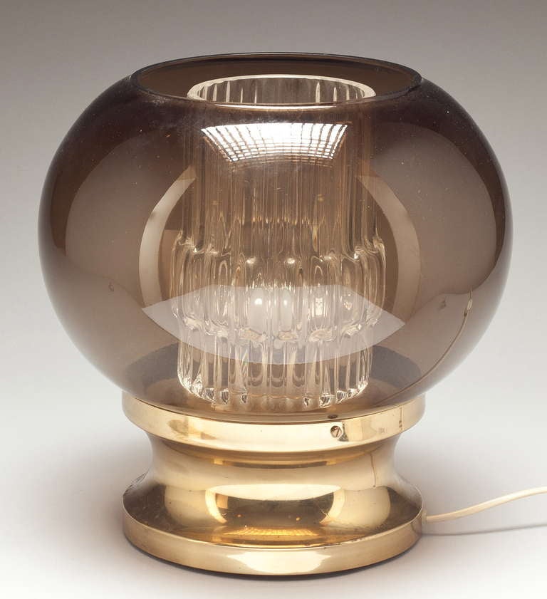 A table lamp by Carl Fagerlund for Orrefors, Sweden, circa 1970s. Double glass shade and brass.
H-12