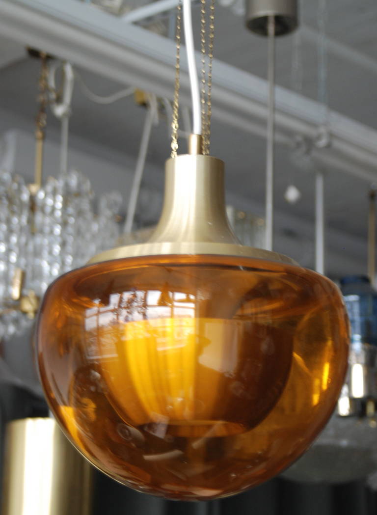 Pendant in Style of Hans Agne Jakonsson, probably Sweden, Circa 1960th.
Colored glass shade with brass hardware. Single Edison style socket.
Diam, 12