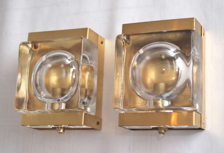 A set of three wall lights by Vitrika, Sweden, circa 1970.
Clear glass and brass. Dimensions: 7