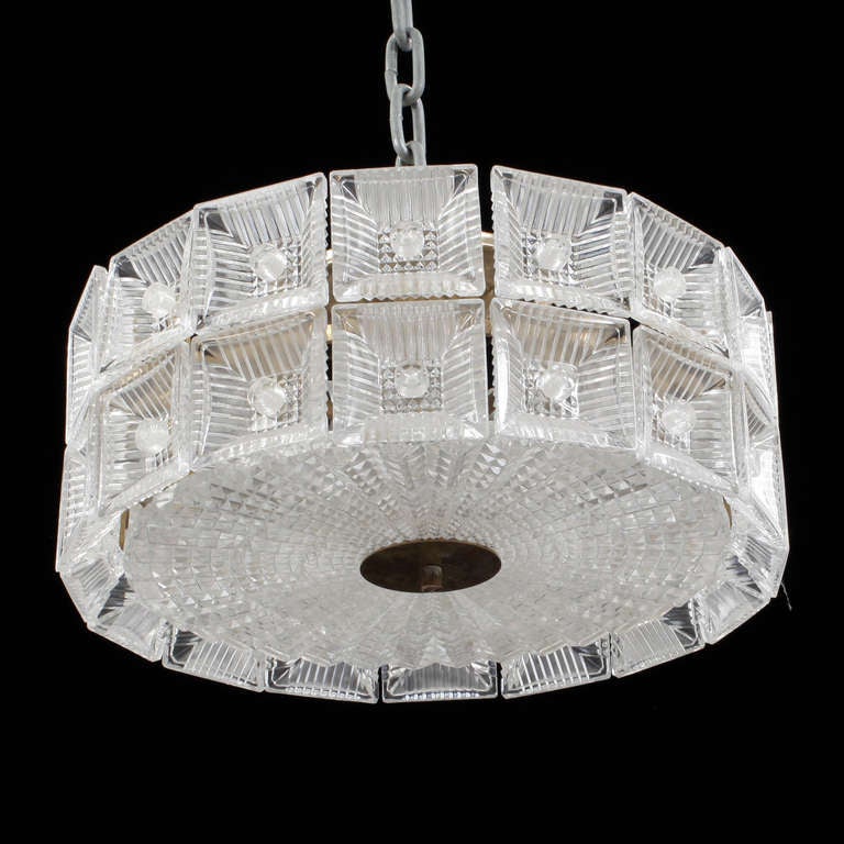 A pendant by Carl Fagerlund for Orrefors.
Clear textured glass with brass hardware.
Existing European wiring, rewiring available upon request.
Two fixtures available. Pricing for each. Two available.