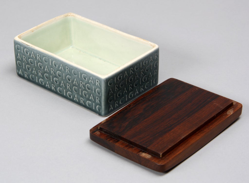 Jens H Quistgaard / Kronjyden Cigar box. Ceramic box with wood lead.  L. 15.5 D 10.5 H 7 cm.
Marked 