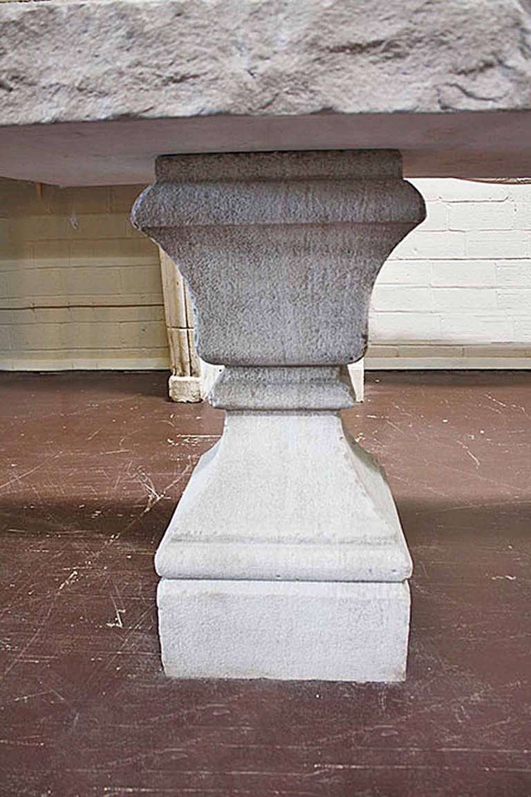 Two limestone bases holding a limestone tabletop creating an enjoyable outdoor or indoor table.