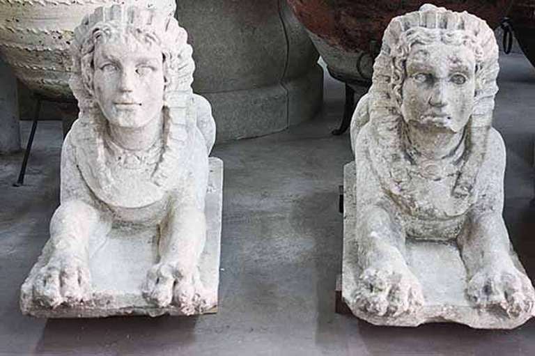 Pair of antique limestone sphinx that were hand-carved and recovered from Southern France.