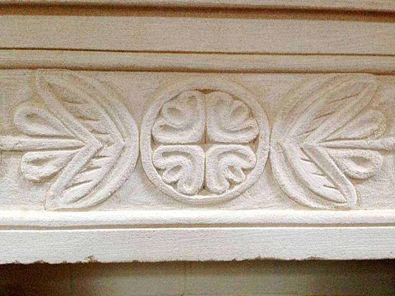 Louis XVI limestone mantel. This lovely beige antique trumeau mantel displays beautifully carved connecting flower like designs. The flower like design runs across the length of the lentil as well as borders the upper trumeau.

Firebox