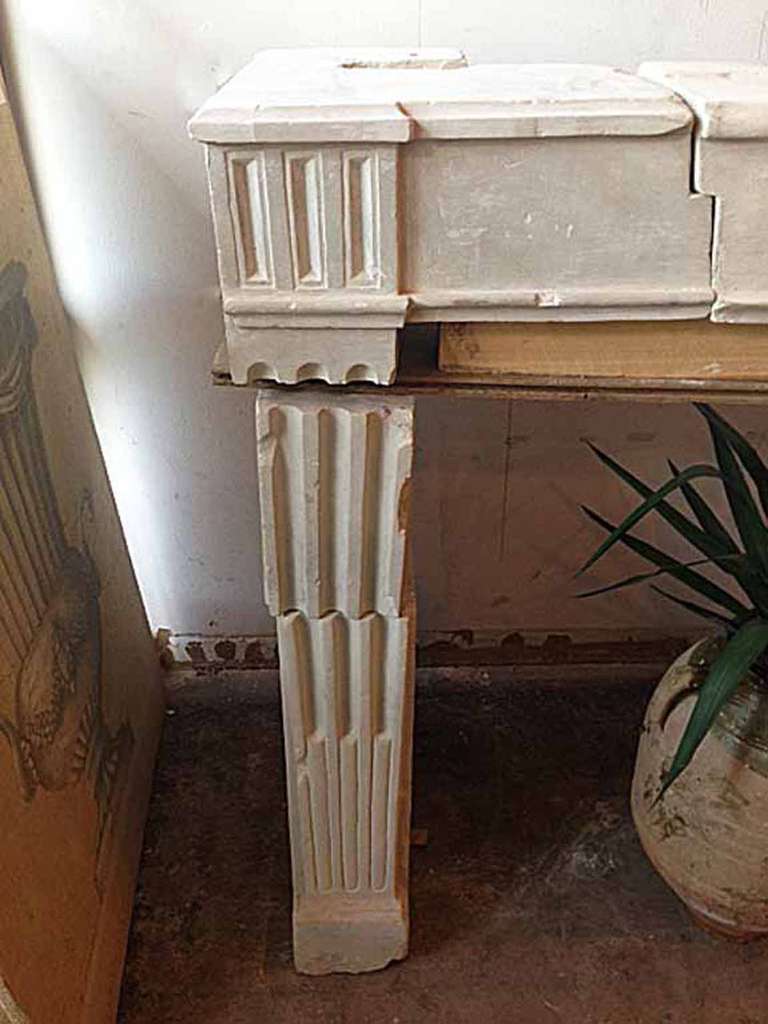 Antique Louis XVI French mantel with reverse flute design on the legs and a solid clean lintel.