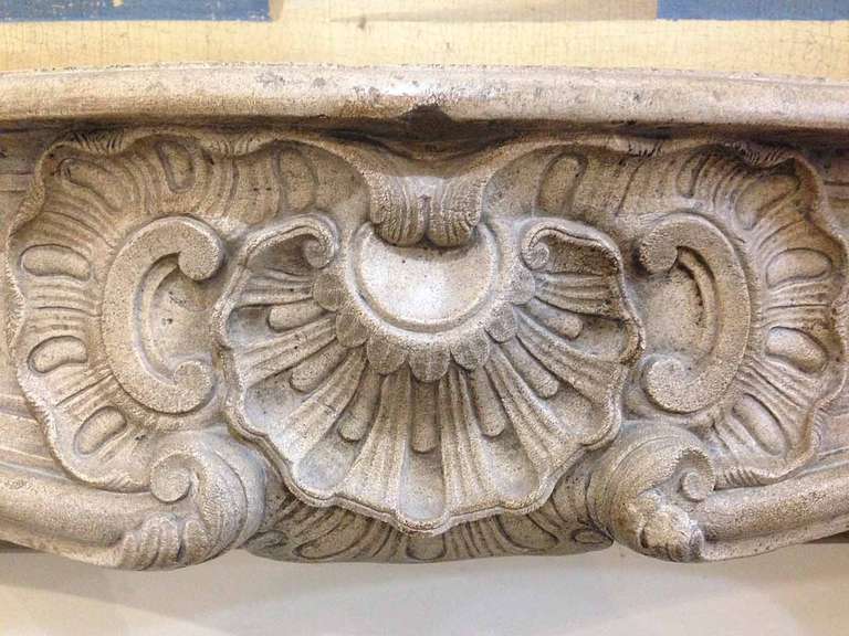 Carved by a French craftsmen out of beautiful limestone, this antique mantel provides unmatched beauty with it's detailed medallion and would be a charming piece in your home.