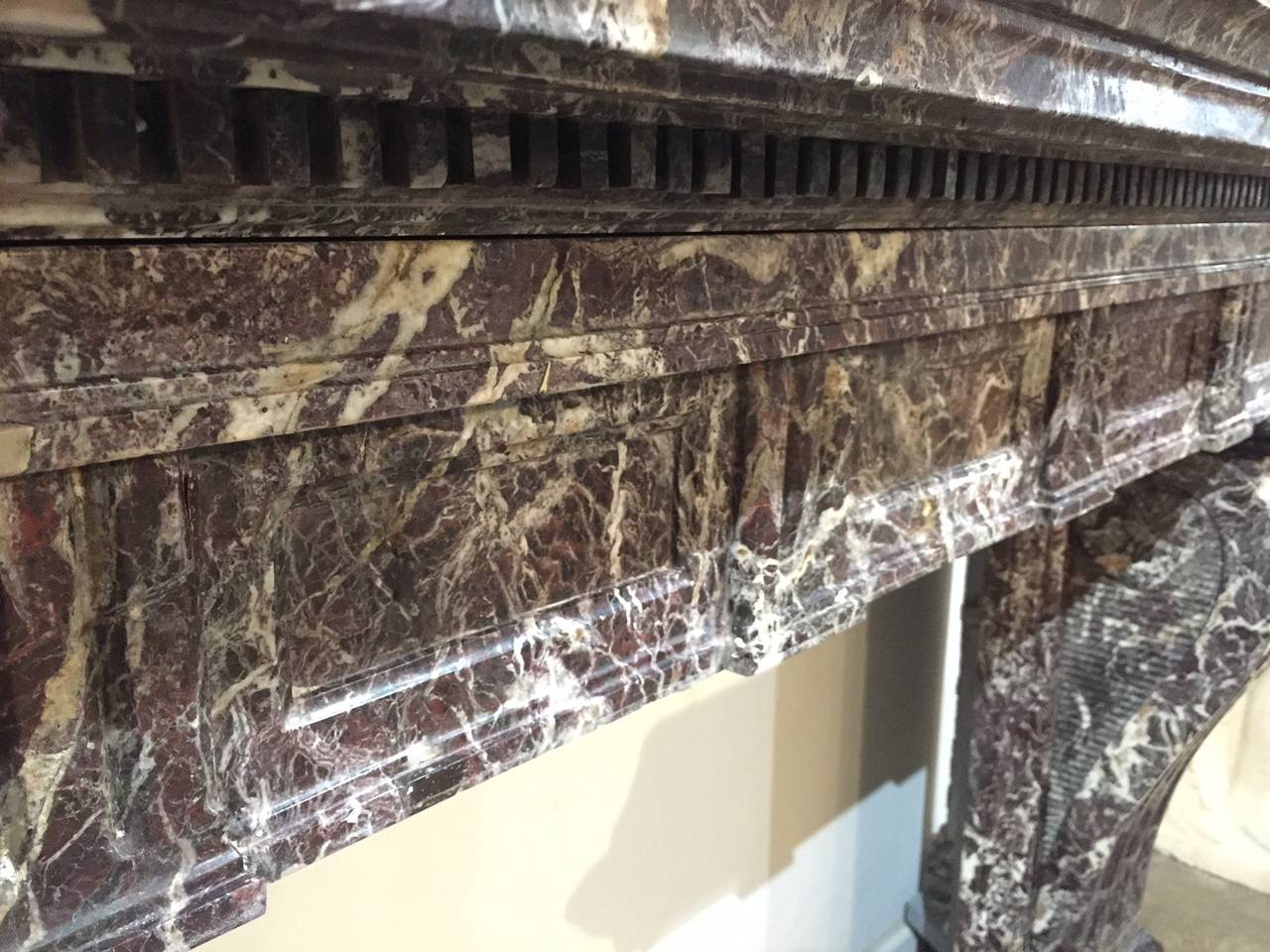 Invite ornate, French beauty into your home with this large Louis XIV marble mantle. Carved in France circa 1850, this monumental, heavily weighted mantle would make an impressive statement in an elegant living or dining room. This mantle is