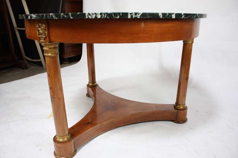 A fine period Empire marble topped foyer table in Cherry with expertly chased Dore Bronze ormolu. 