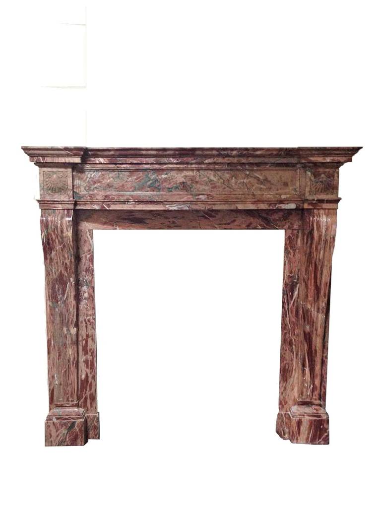 This antique Breche marble mantel features legs that protrude slightly at the top and taper down. Above each leg on either side of the lintel you will find a shell motif.

Measurements: 70″ W x 66 1/2″ D x 13 1/2″ H.
Firebox: 43″ W x 49″ H.