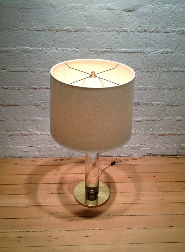 A lamp by Frederick Cooper of Chicago.
Thick solid lucite column with polished brass fittings, the cord openly concealed in the lucite, nearly invisible at most all angles.