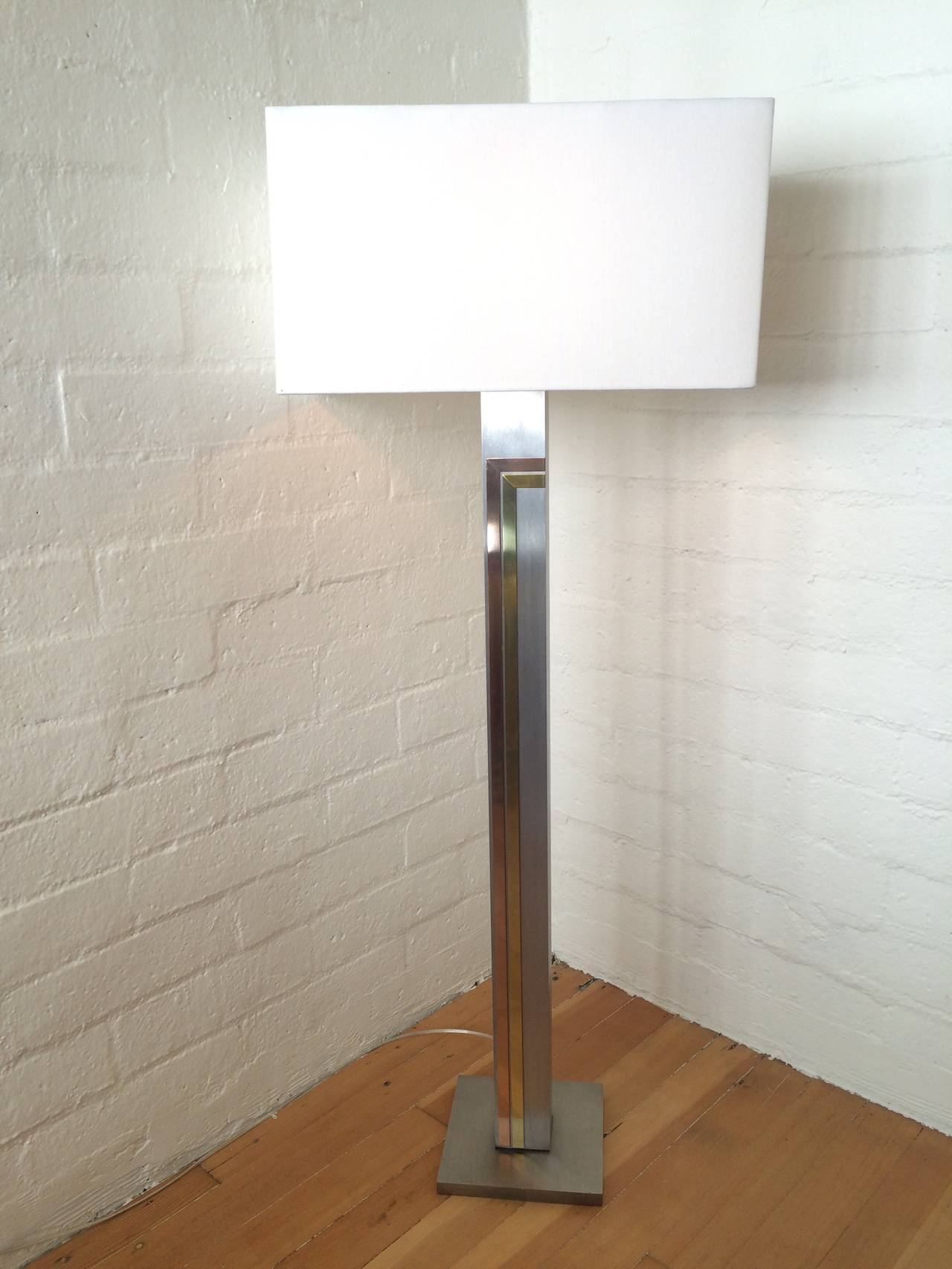 A brushed steel with brass and copper accents floor lamp designed by Pierre Cardin and made by Laurel Co. 
Newly rewired and new shade.