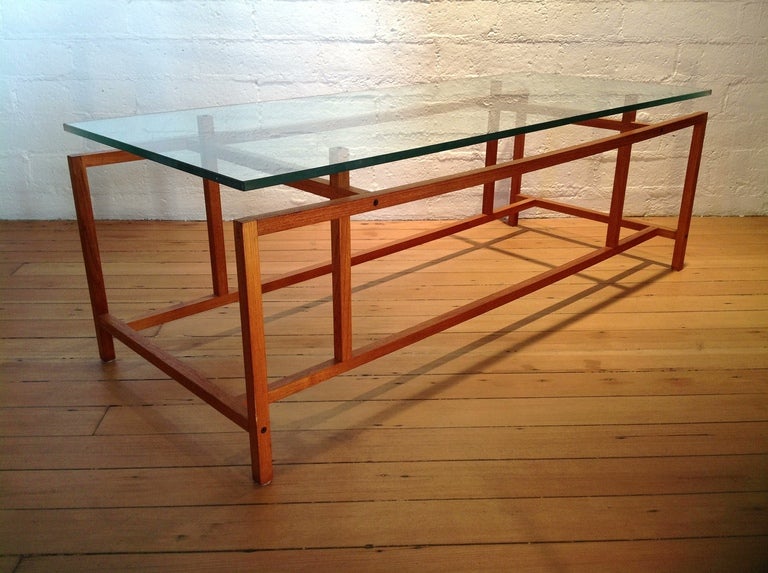 Cocktail Table
Stained Teak base with a glass top.
The Glass has drilled holes that let it sit on the base without any movement. 
This table was Designed by Henning Norgaard and manufactured by Komfort.
