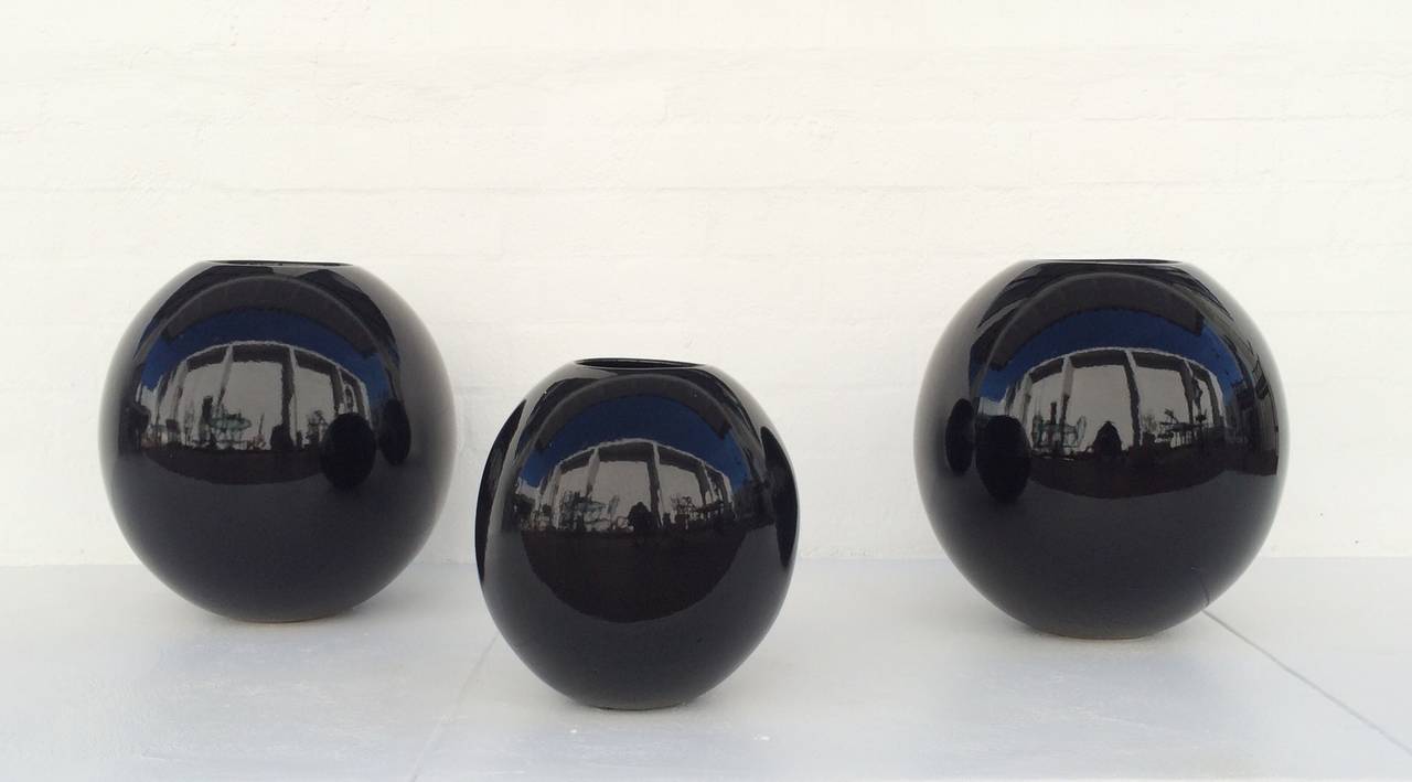 We are offering three black high gloss finish ceramic planters designed by Marilyn Kay Austin for Architectural Pottery. 
All three are in excellent condition with minor wear consistent with age. 
Two are 19
