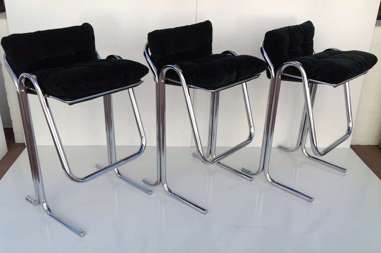 A set of three chrome base bar stools with plush green loose seat and back cushions designed by Jerry Johnson. Circa 1960s