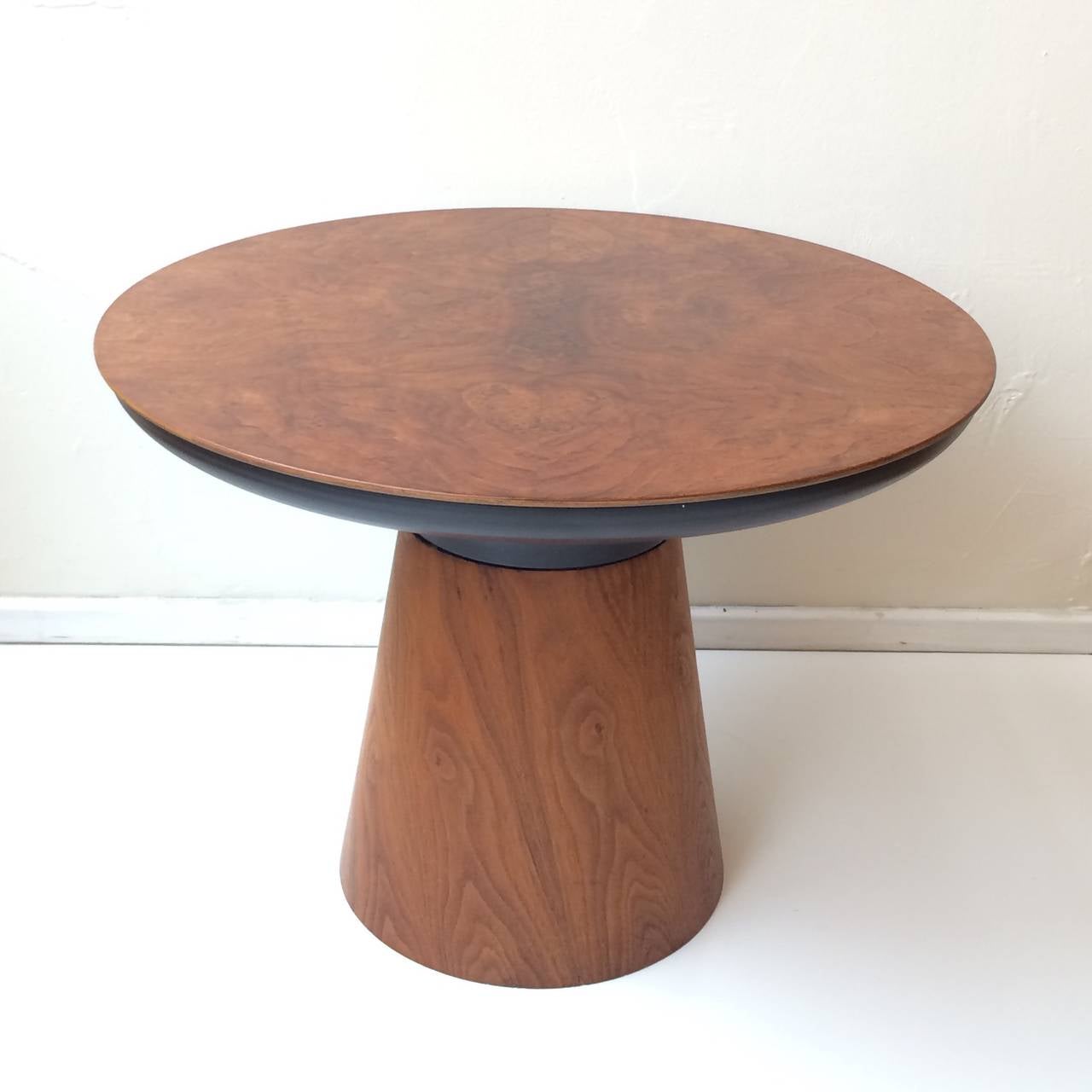 An attractive side table designed by Frank Rohloff.
This table consist of a walnut base with a black metal cone shaped top part that supports a removable inset walnut top.
This gorgeous table was designed in 1968.
