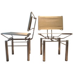 A pair of Chrome &  Stainless Steel Mesh  Chairs