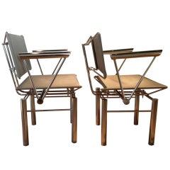 A pair of Chrome &  Stainless Steel Mesh Arm Chairs