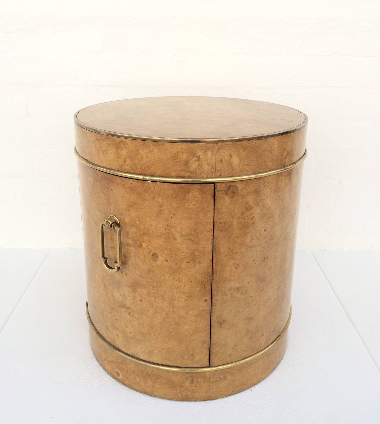 A stunning burl wood with brass accents and brass door pull cabinet or side table made by Mastercraft.
A curved door opens to reveal a large storage space.
circa 1970s.