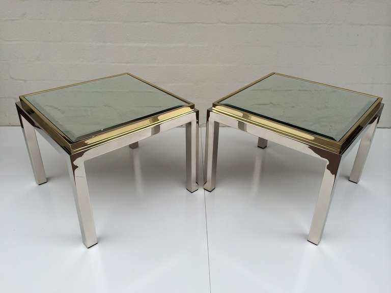 A pair on newly re-plated nickel and polished brass side tables with inset mirror tops.