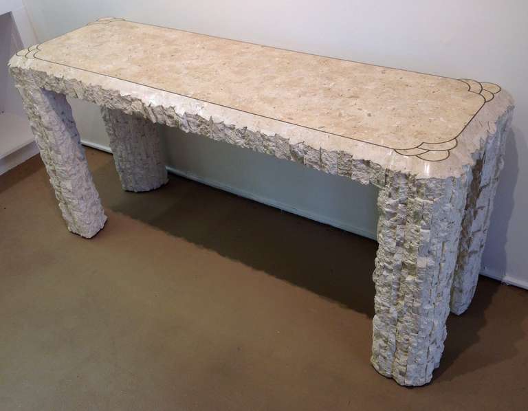 A stunning console table by Maitland - Smith.
This table is travertine with brass inlay accents.