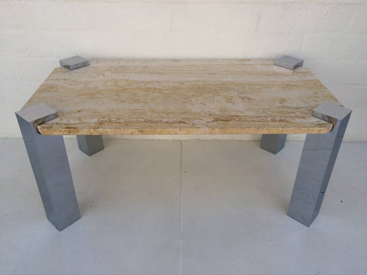 An attractive polished chrome cocktail or coffee table with a travertine top,
circa 1970s.