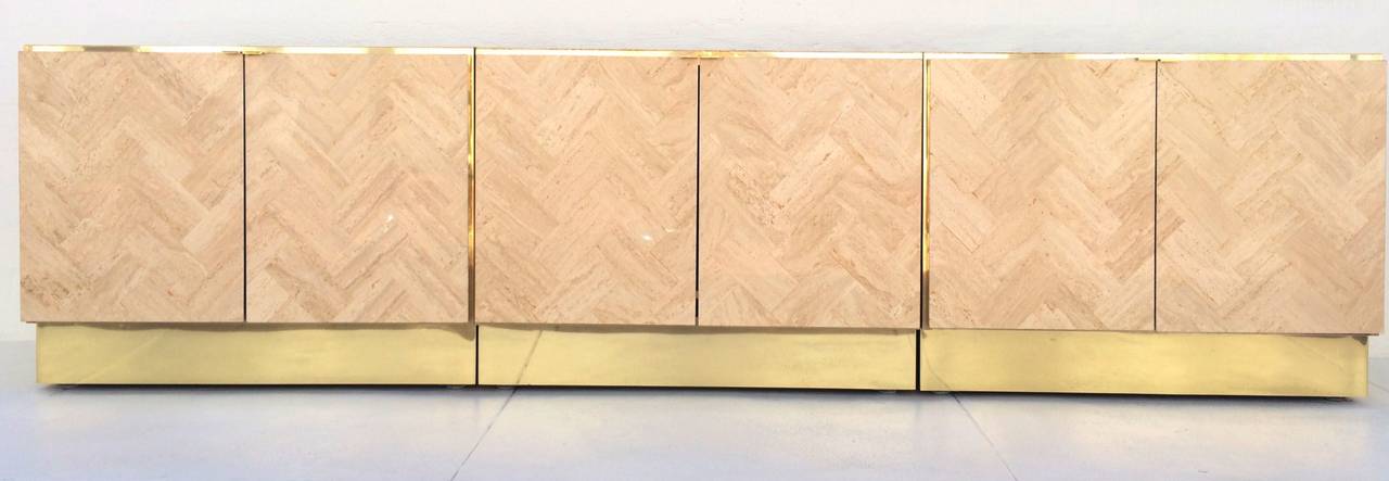 Set of three stunning Italian travertine cabinets with brass trim are pulls.
Made by Ello.
circa 1968.
These cabinets can be set up side by side to create one large cabinet or they can be set up individually.
All three had brass laminate