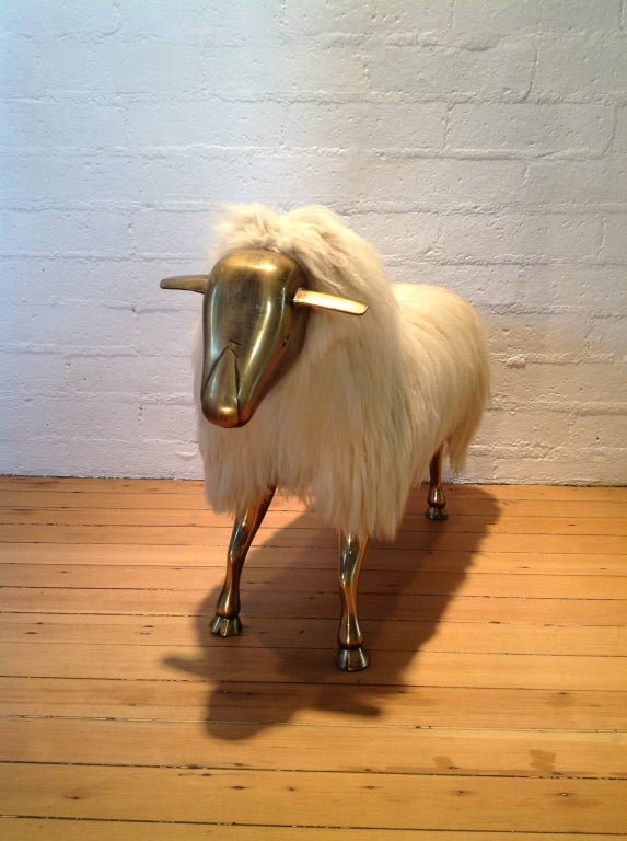A spectacular life-size sheep, with a wood body covered in sheep wool. The head and legs a heavy brass.
It is not signed anywhere,but it is very much in the style of Lalanne?