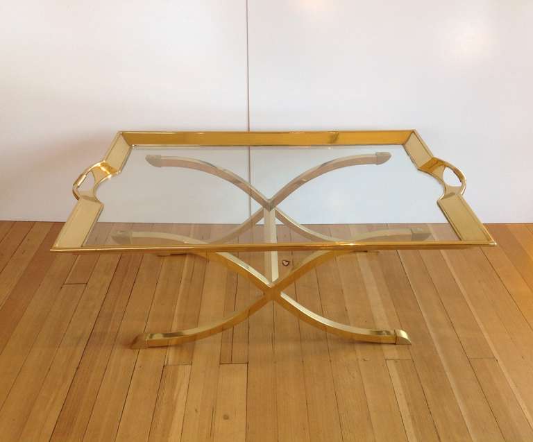 For you consideration a large polished brass with glass tray top cocktail/coffee table.
This table consist of a heavy polished brass xBase, with a glass and brass tray tops that has handles.
Made by La Barge circa 1970s