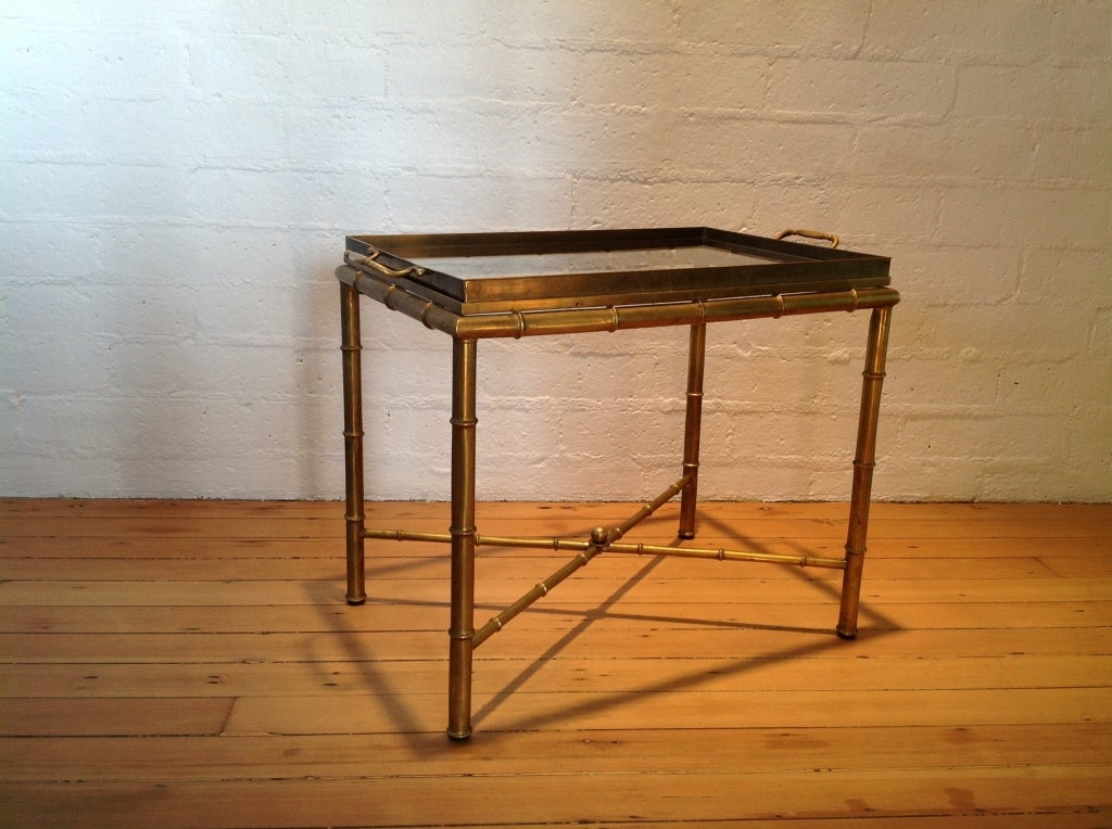 A brass and glass tray table by Mastercraft.
Tray has handles and can be lifted out to serve with.