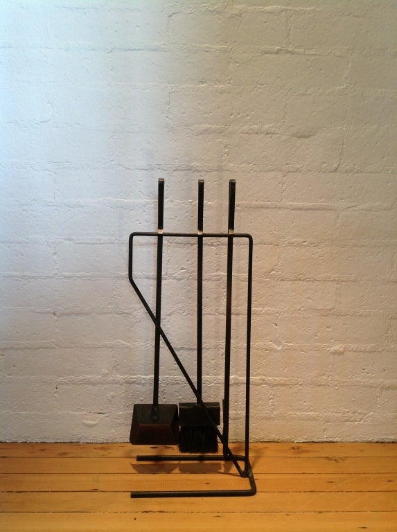 A Set of wrought iron fireplace tools with stand.
This set is very much in the style of George Nelson....