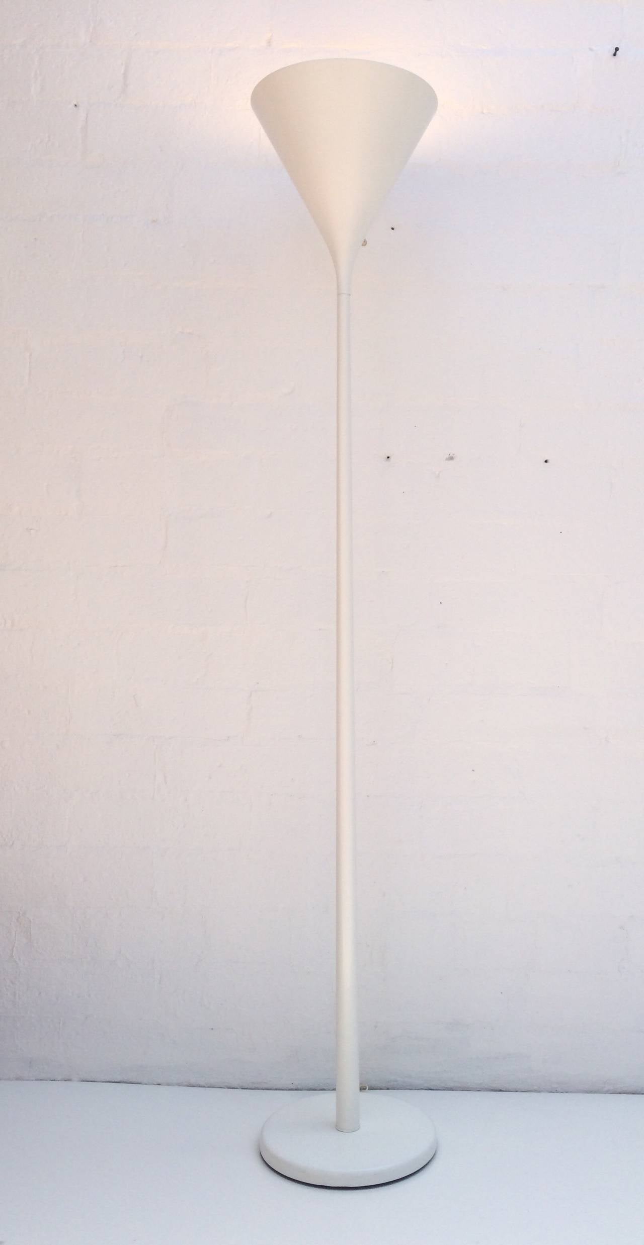 This simple elegant white powder-coated torchiere lamp by Nessen Studio is newly rewired.
circa 1970s.