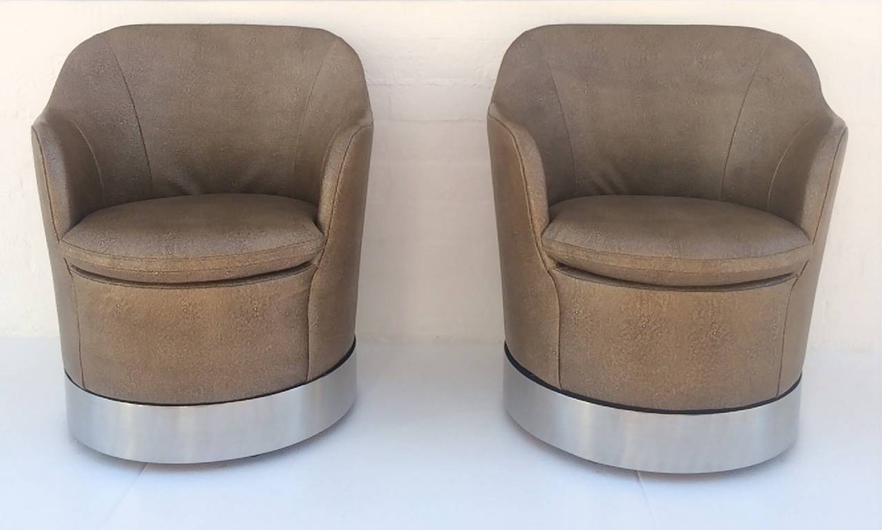 A pair of swivel lounge chairs by Phillip Enfield. 
Stainless steel base with newly reupholstered Shagreen leather. 
These gorgeous chairs swivel 360°,
circa 1960s