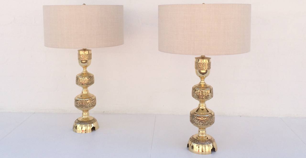 These phenomenal lamps in the style of James Mont are solid brass and have been professionally polished to brilliant shine.  
Newly rewired with all new polished brass hardware.  
New oatmeal linen Shades