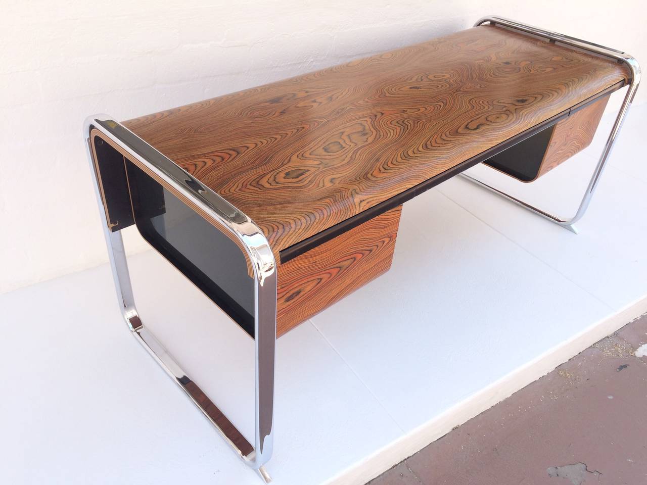 This very attractive zebra wood and chrome desk is designed by Peter Protzman for Herman Miller, circa 1970s. 
Lots of storage with a file drawer on each side and a large middle drawer.