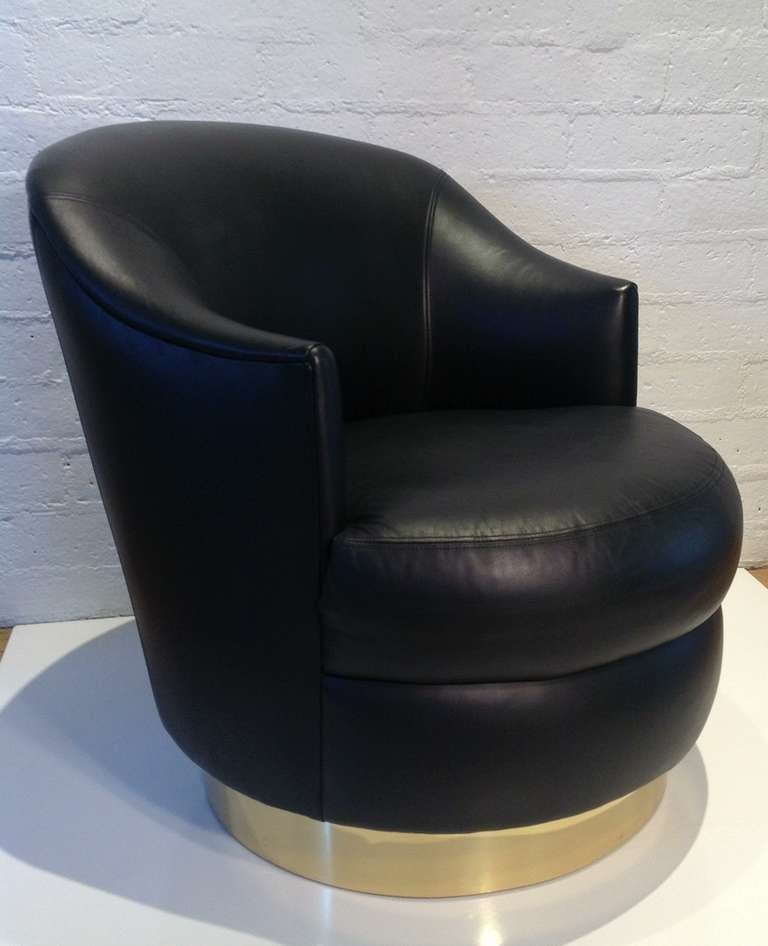 Black leather swivel chair designed by Karl Springer.
 Smooth soft rich black leather all original .
Wood base with a brass band around it
