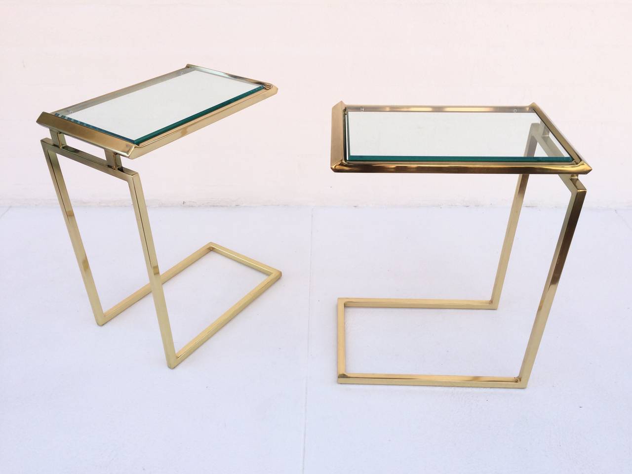 A pair of rare polished brass with inset beveled glass top side tables.
These beautifully designed side tables are by Milo Baughman, circa 1970s.
Perfect for cocktails and hors d'oeuvres.