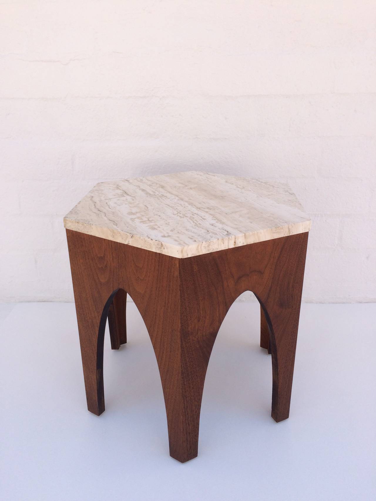A hexagon occasional table designed by Harvey Probber.
This attractive table consist of a walnut base and a polished travertine top.
circa 1950s.