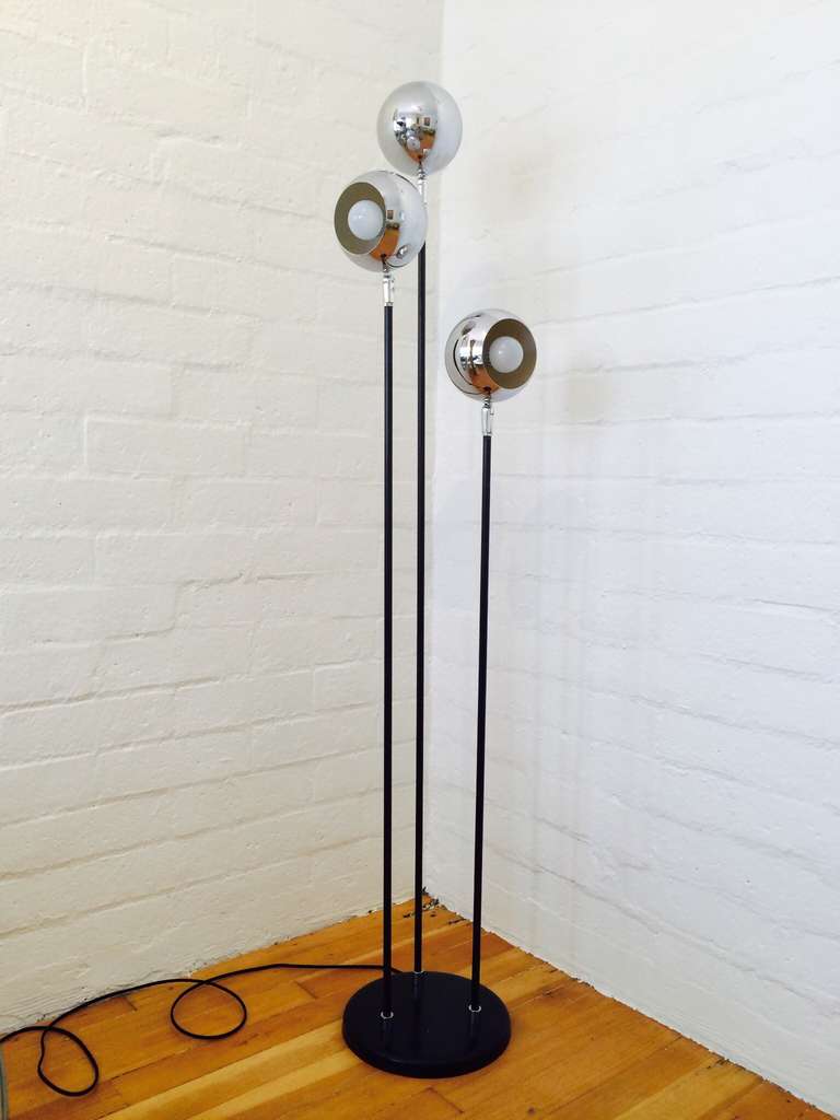 A floor lamp bye Raymor consisting of three chrome ball light and black painted metal base.  
Newly rewired.