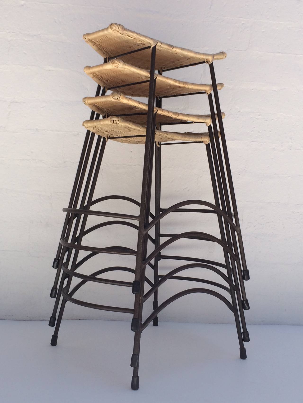 Mid-20th Century Set of Four Wicker and Painted Steel Stools Designed by Arthur Umanoff