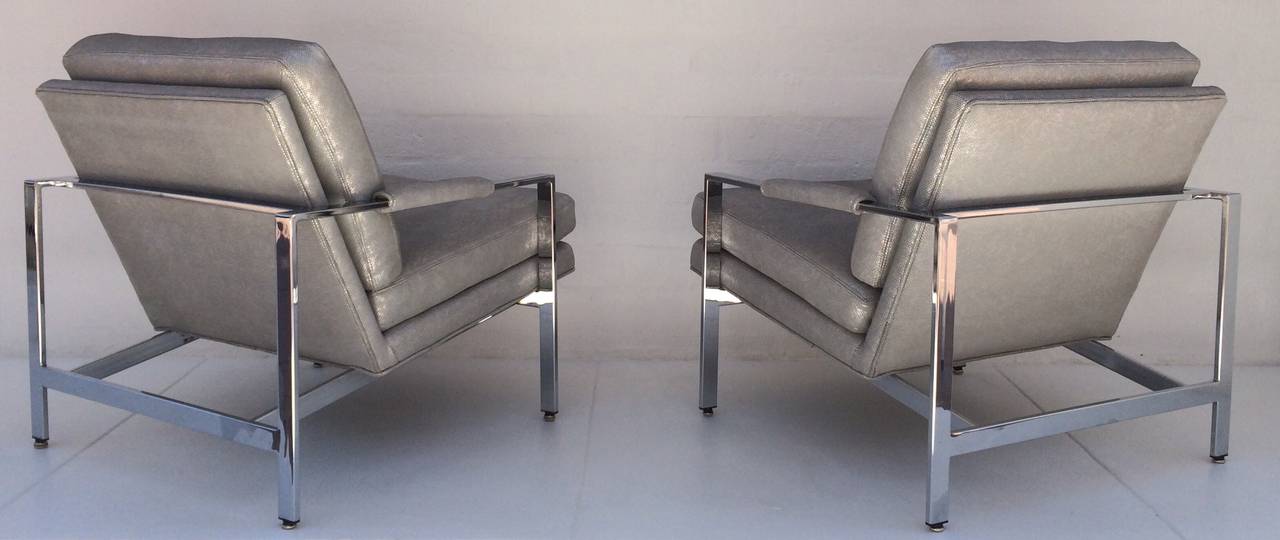 A pair of newly reupholster polished chrome lounge chairs designed by Milo Baughman for Thayer Coggin. 
These chairs retain the Thayer Coggin labels.  
Reupholsterd in a sliver metallic mesh pattern leather.
