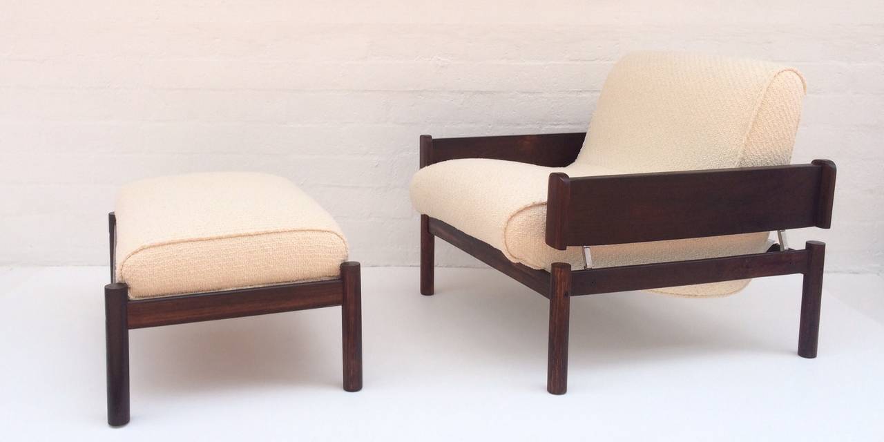 A 1960s rosewood lounge chairs with matching ottoman. 
Newly reupholstered in a off-white nubby fabric. 
The frames of both the chair and ottoman are solid rosewood.
As seen in the photos, the one-piece seat floats on the frame. 

Dimensions: