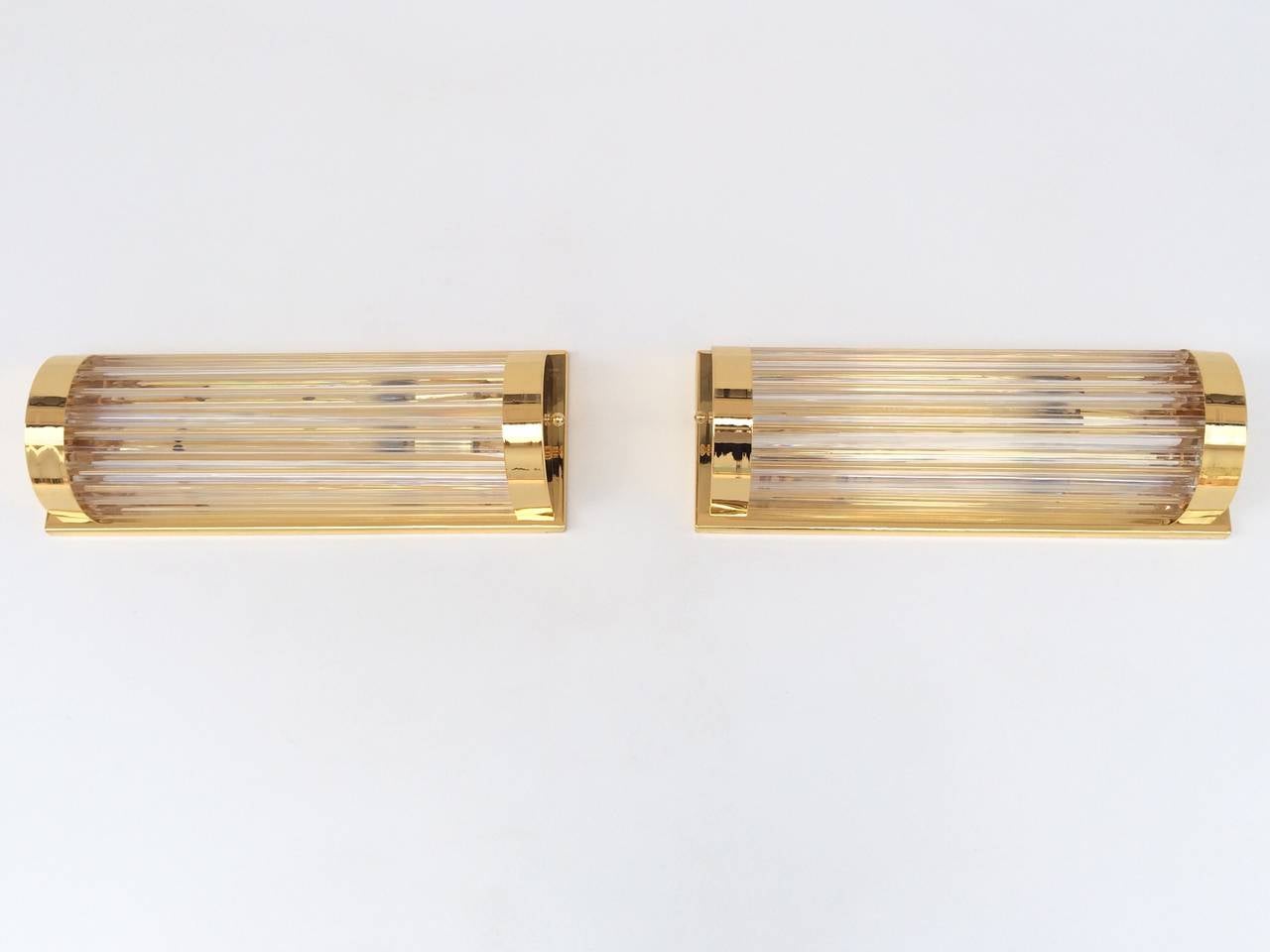 A pair of rare Murano wall sconces designed by Venini.
Polished brass with glass rods. 
Like new condition!