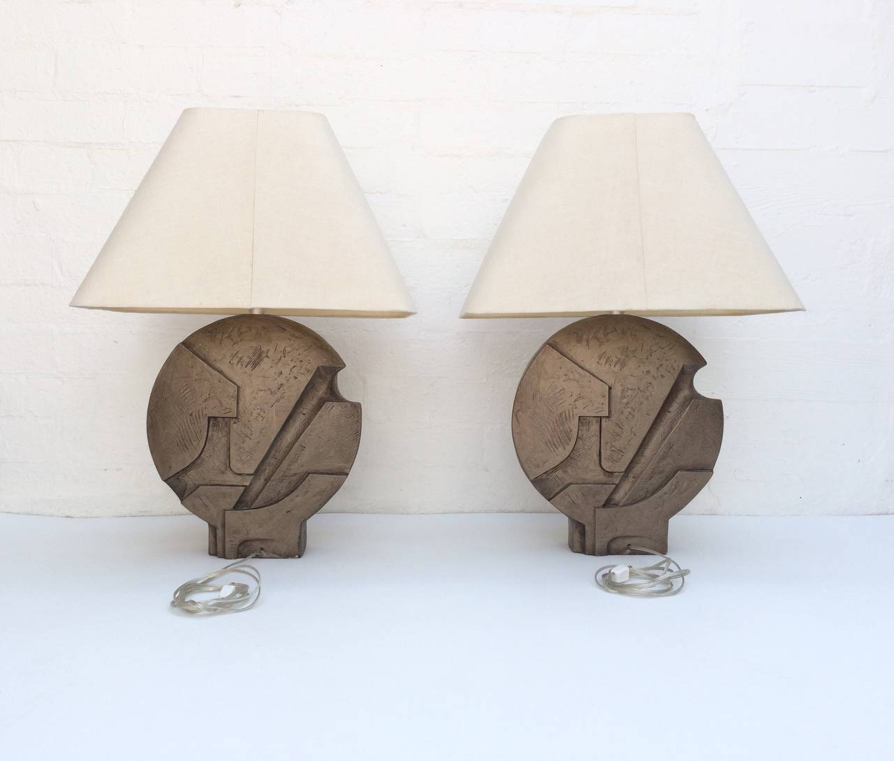 A pair of painted plaster sculpture tables lamps.
These attractive lamps are from the 1960s and are painted with a bronze finish.
Newly rewired and all new nickel hardware.